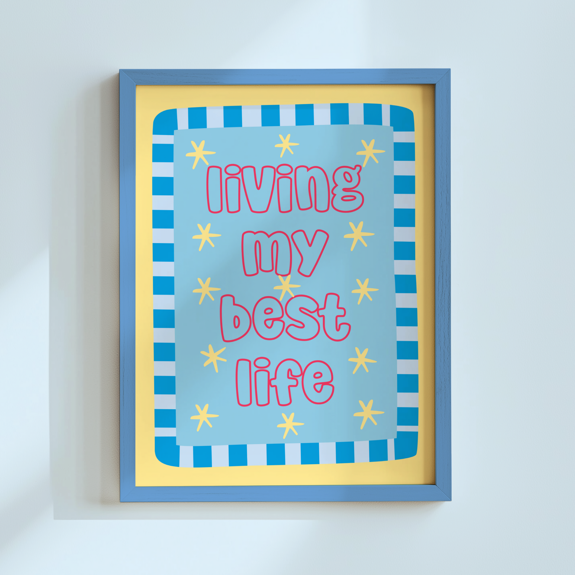 Framed artwork with 'living my best life' text on a light blue background